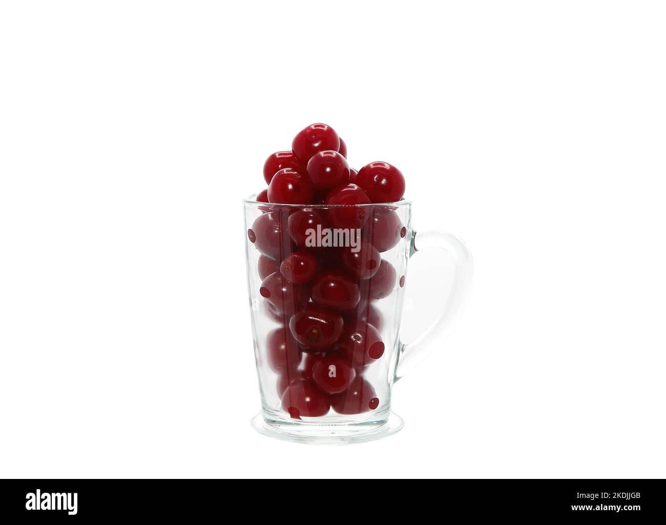 Ripe cherry in a transparent glass on a light background. Natural ...