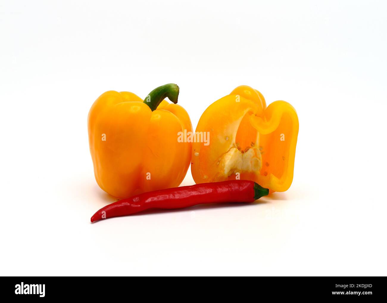 Composition of yellow and red sweet peppers of different sizes on a