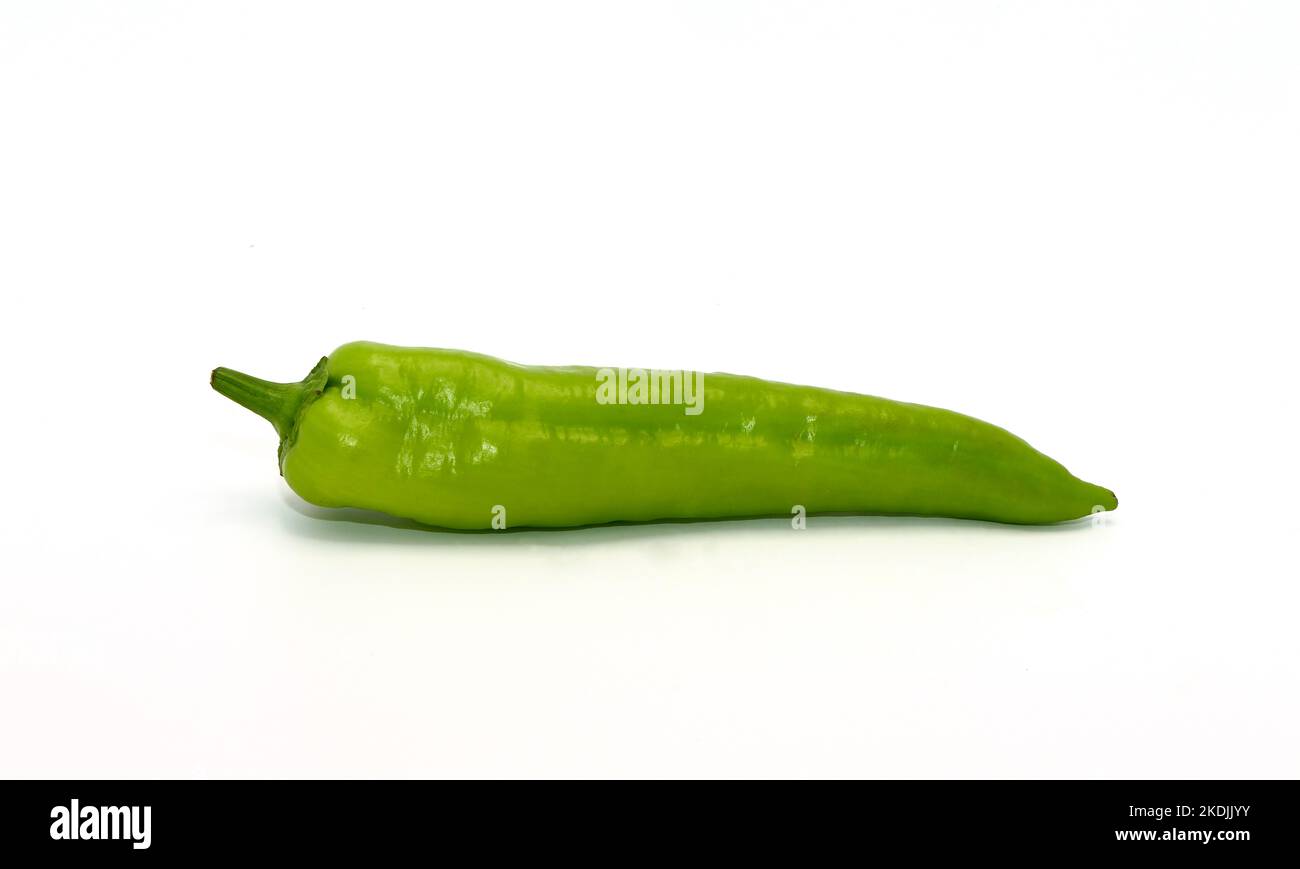 One pepper of green color on a light background. Natural product