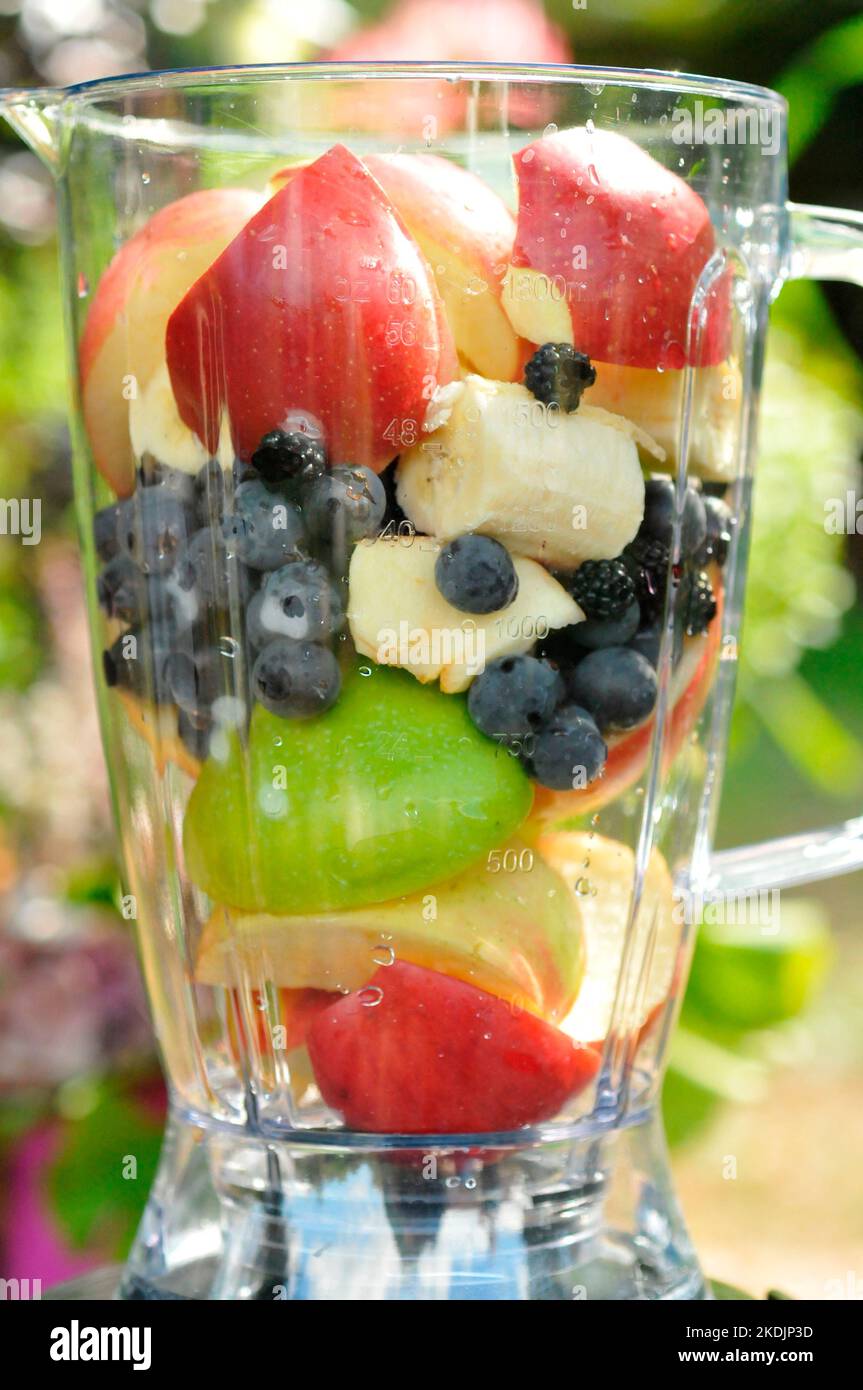 Fruit mix in a blender, apples, grapes, blackberries, banana, for