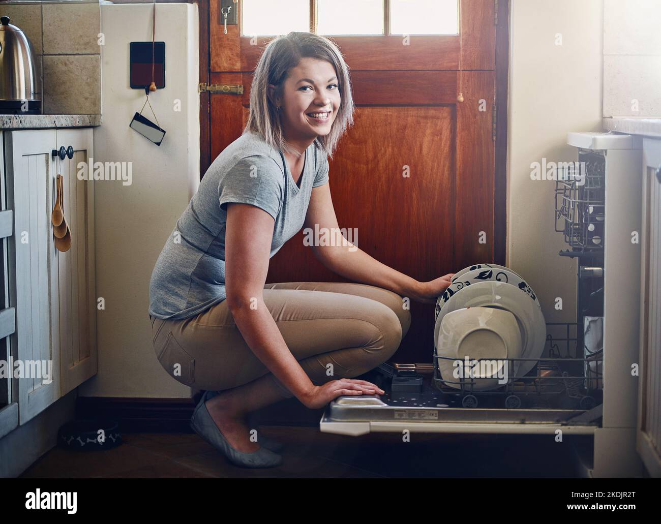 The dishwasher is every homemakers best friend. Portrait of a young