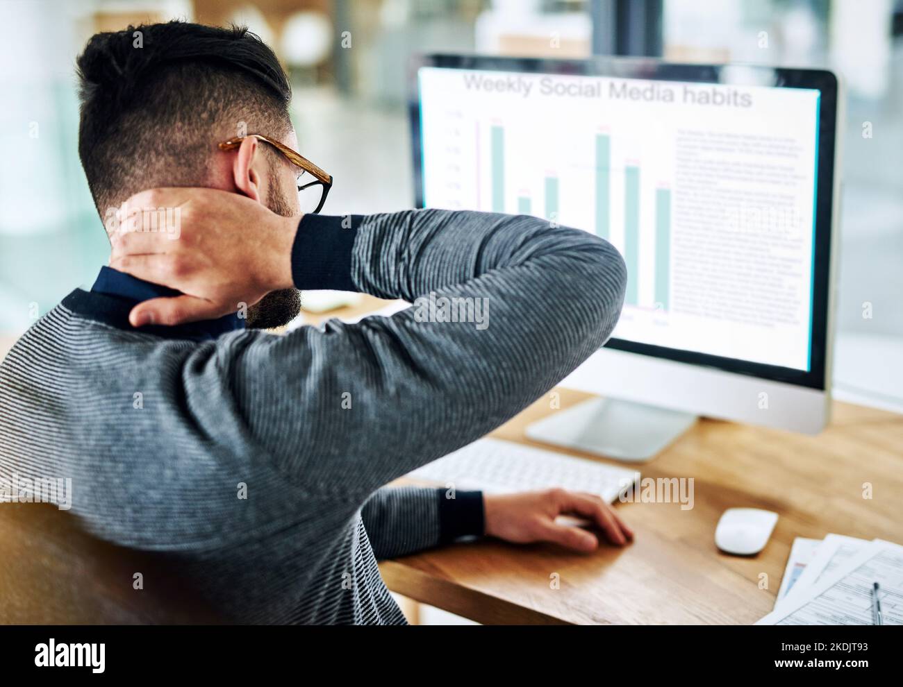 Feeling the strain and tension creep into his neck. a young designer