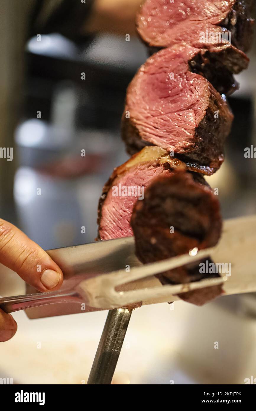 Picanha is a BBQ Steak meat grilled in charcoal. Knife cutting on