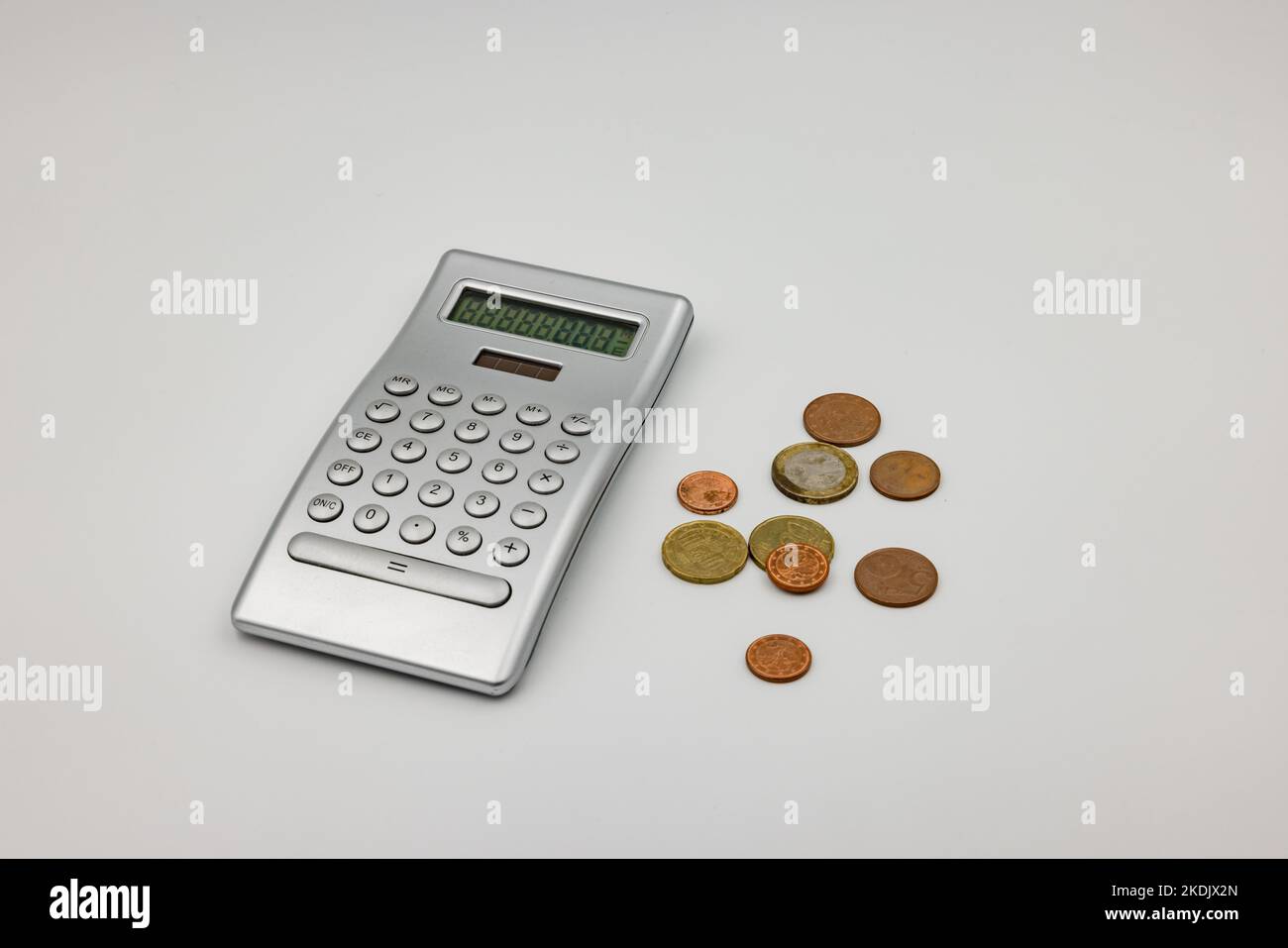 Poverty and small change with euro coins and a calculator Stock Photo
