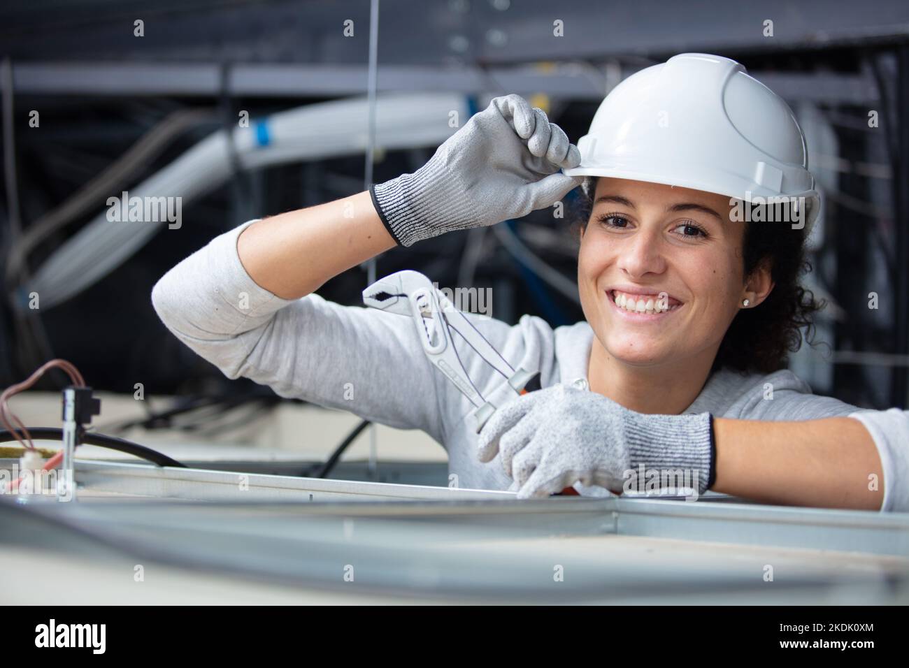 woman tipping her hard hat Stock Photo Alamy