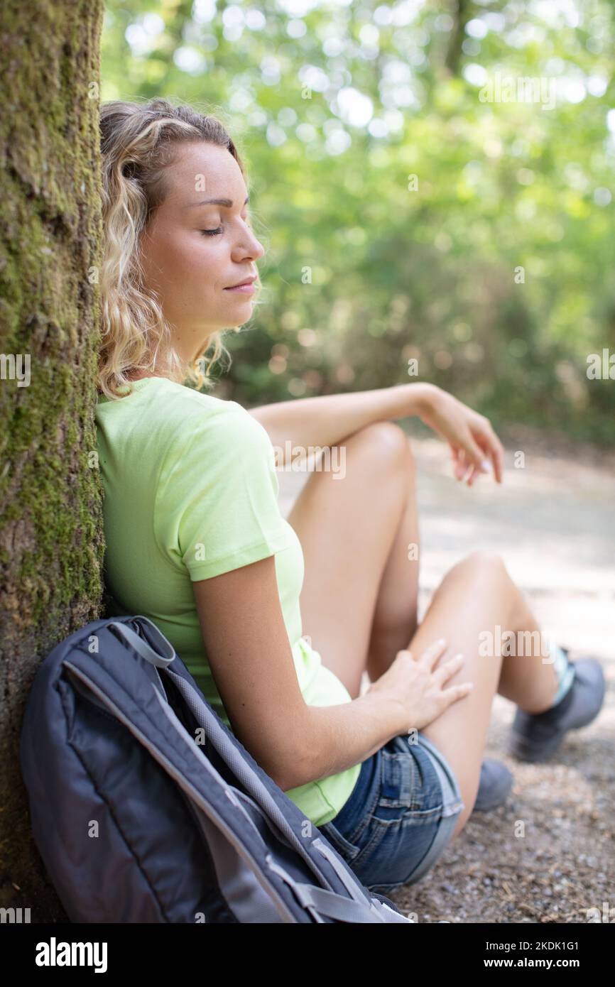 young woman resting after a walk in the forest Stock Photo - Alamy