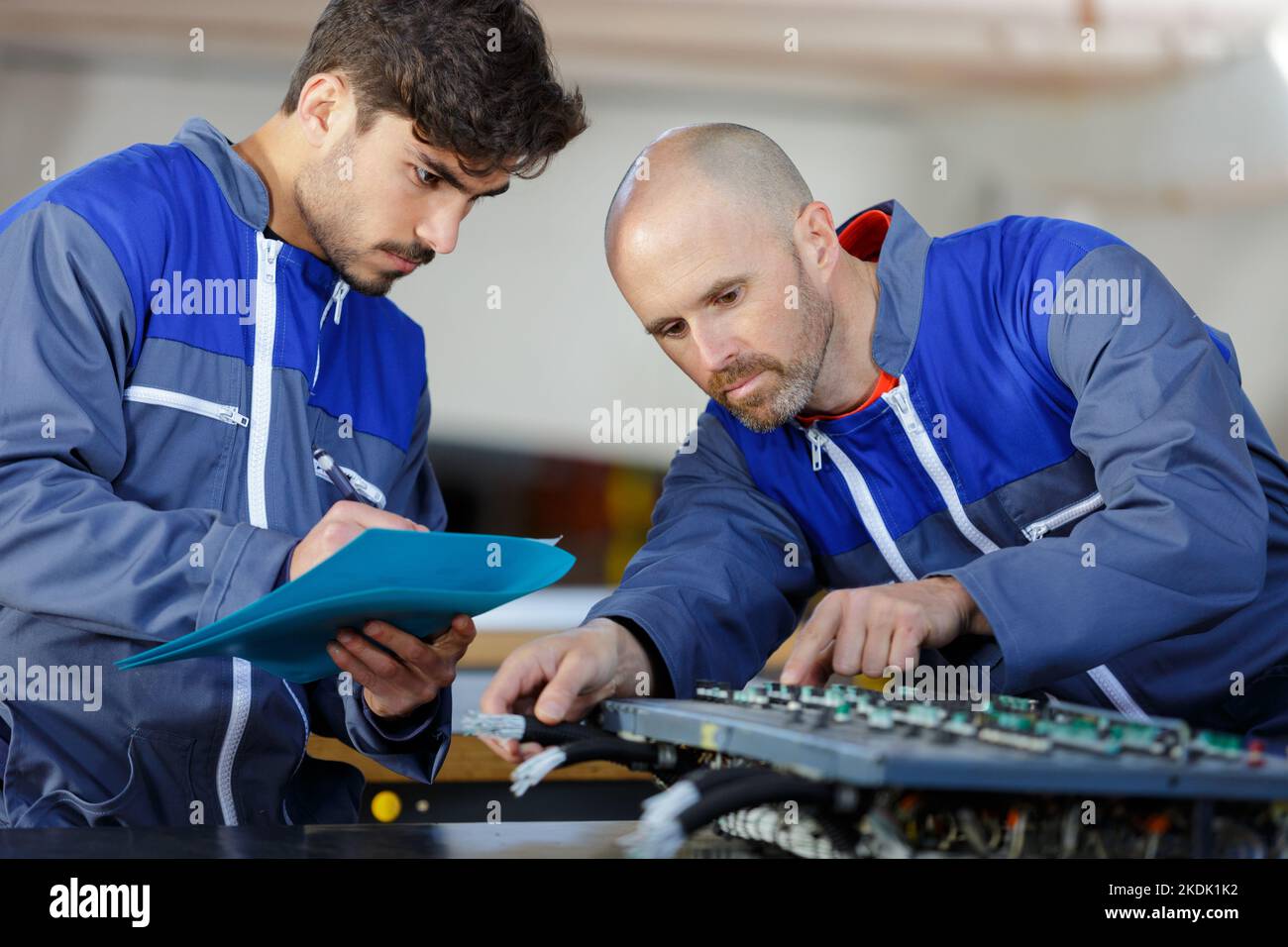two-workers-at-a-manufacturing-plant-stock-photo-alamy
