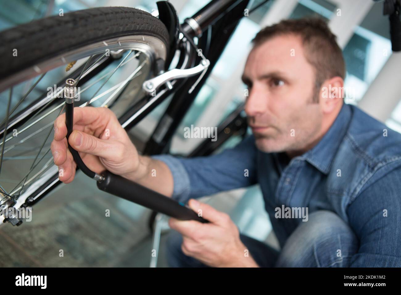 man pumping up a bike tire Stock Photo Alamy