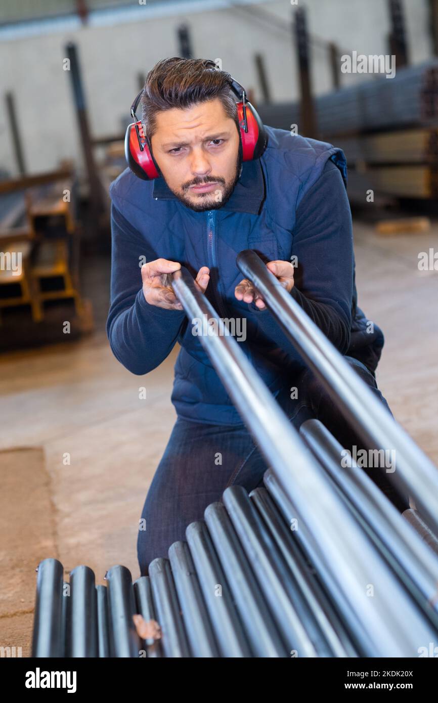 craftsman taking measurements of metal bars Stock Photo Alamy
