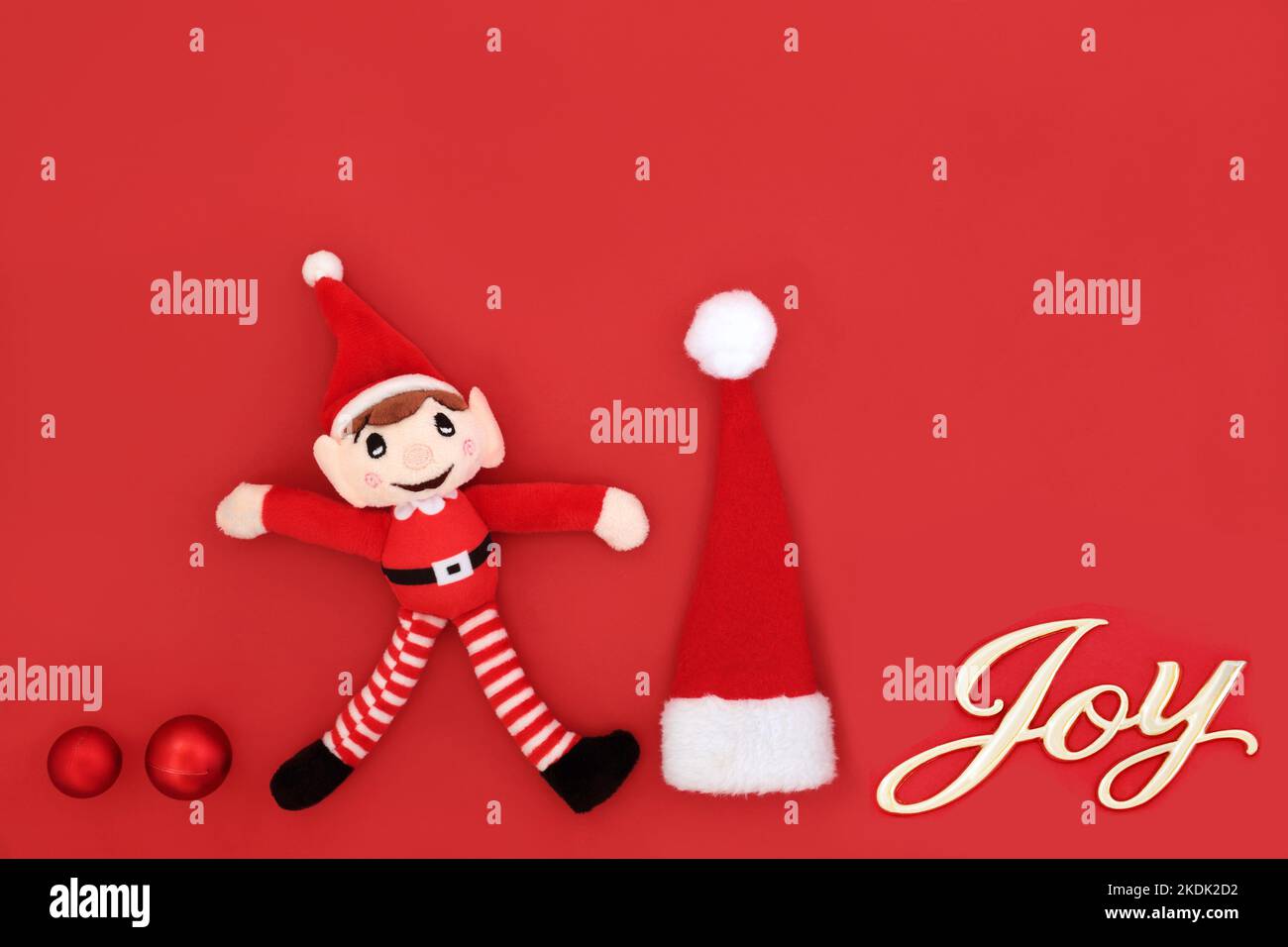 Christmas eve joy sign on red background with santa symbols of elf, hat,  tree ball bauble decorations Fun exciting abstract Xmas happiness concept  Stock Photo - Alamy, image size:1300x956
