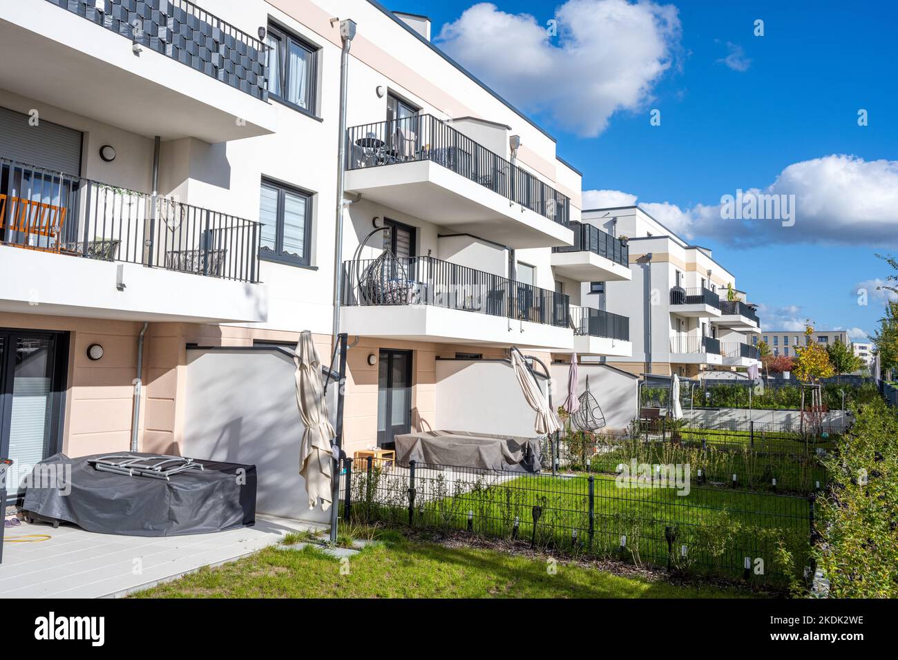 Modern multi-family apartment buildings with balconies and gardens seen ...