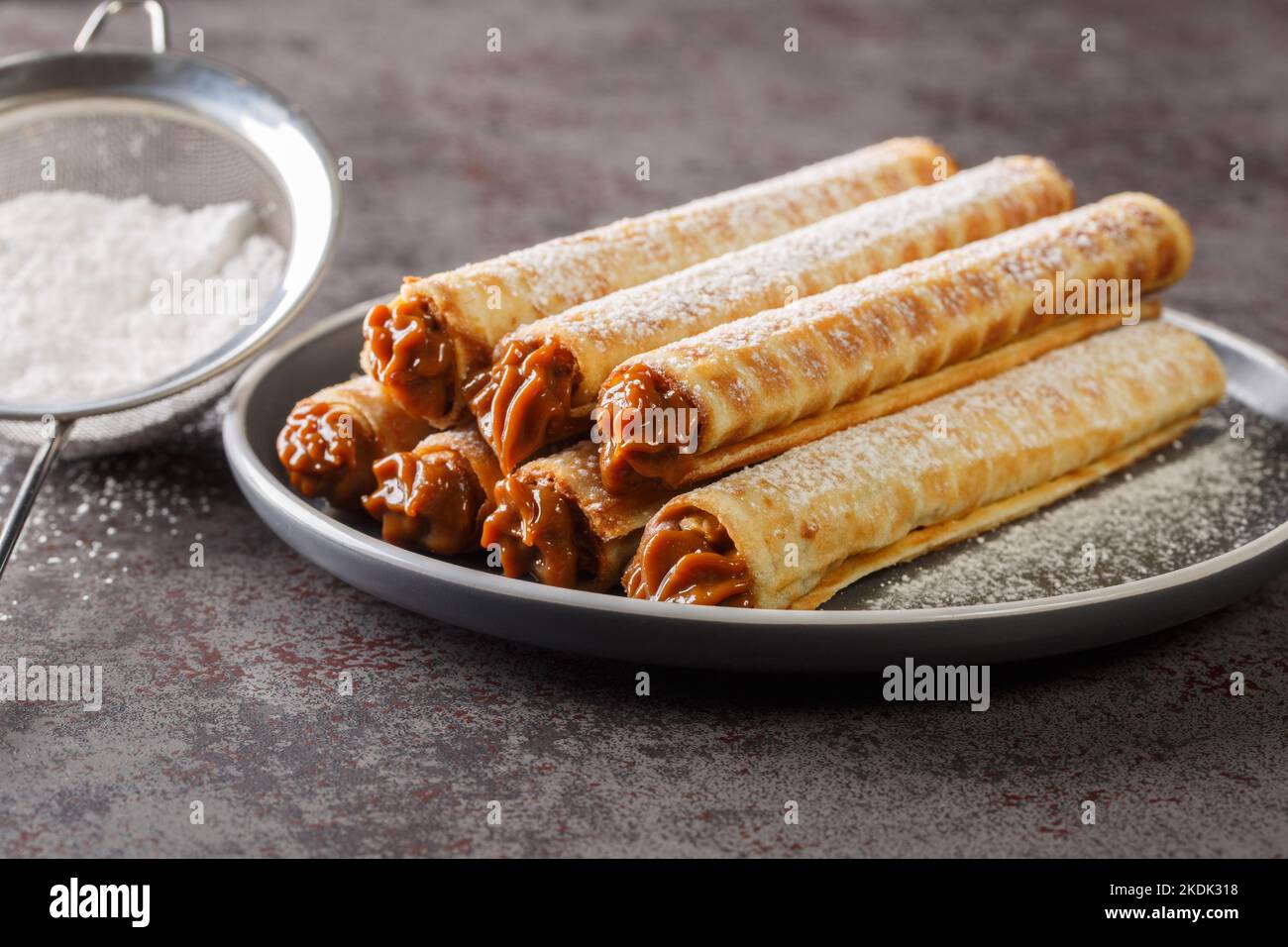 Wafer rolls with condensed milk. Thin and Crispy Waffle. Selective focus. Horizontal Stock Photo