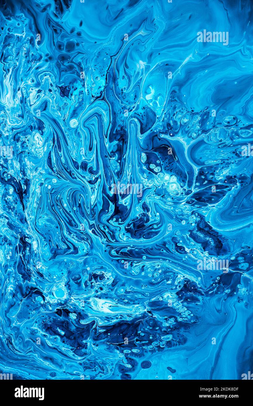Free flowing blue and white acrylic paint. Random Waves and Curls. Abstract marble background or texture. Stock Photo