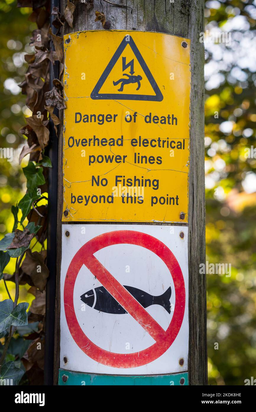 Danger of death, overhead electrical power lines, no fishing beyond this point. Stock Photo