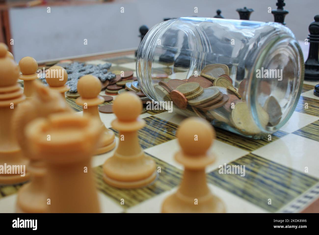 the glass jar of savings in the chess battle of interest rates Stock