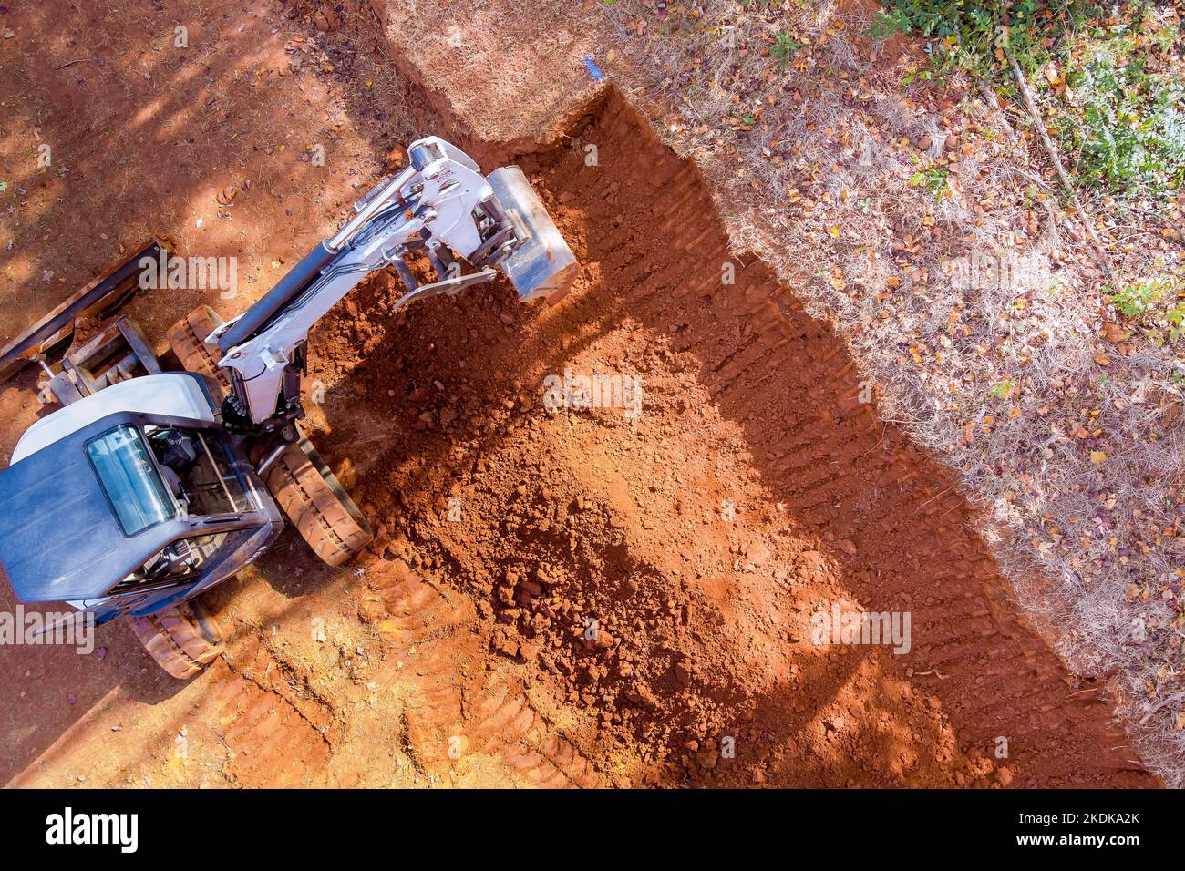 In this construction site crawler excavator bucket digging ground earthmoving works during construction process Stock Photo