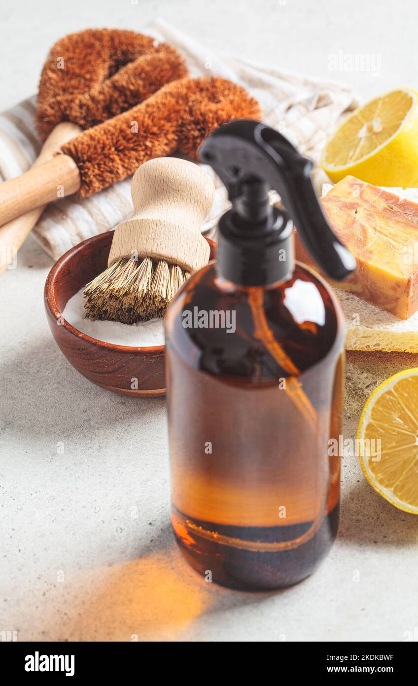 Zero waste eco friendly products and tools for house cleaning. Wooden brushes, coconut sponges, spray vinegar, soda, lemon and organic soap, gray back Stock Photo