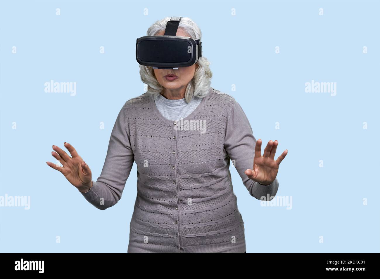 Senior woman with virtual reality headset is shocked by VR experience ...
