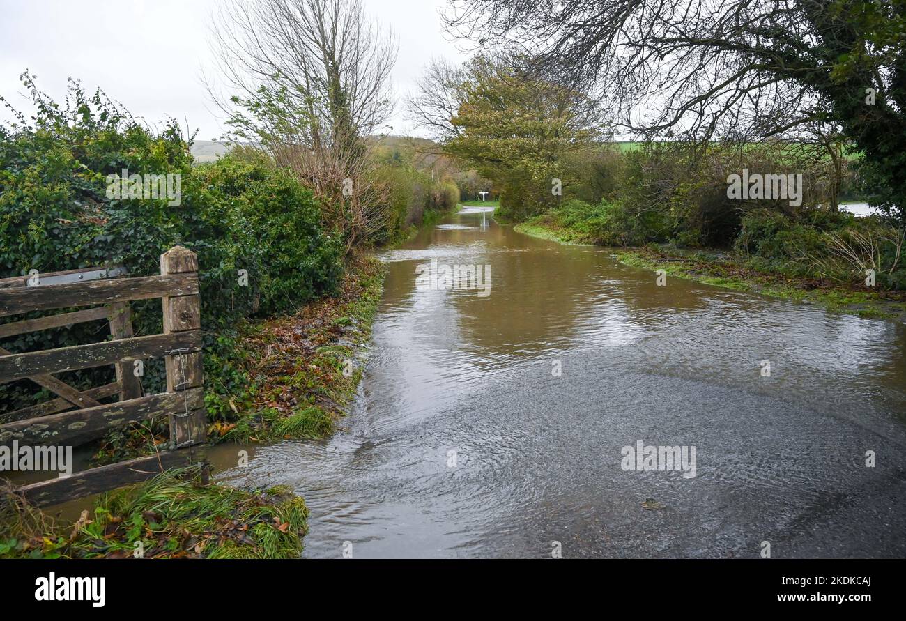 Alfriston East Sussex UK 7th November 2022 - A  flooded lane in Alfriston village in East Sussex after more heavy rain which is forecast to continue across Britain over the next few days : Credit Simon Dack / Alamy Live News Stock Photo