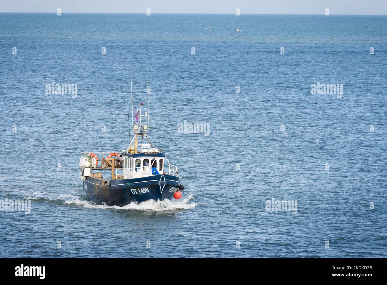 WHITBY, UK - September 21, 2022. North Sea fishing boat at sea sailing toward Whitby Harbour Stock Photo
