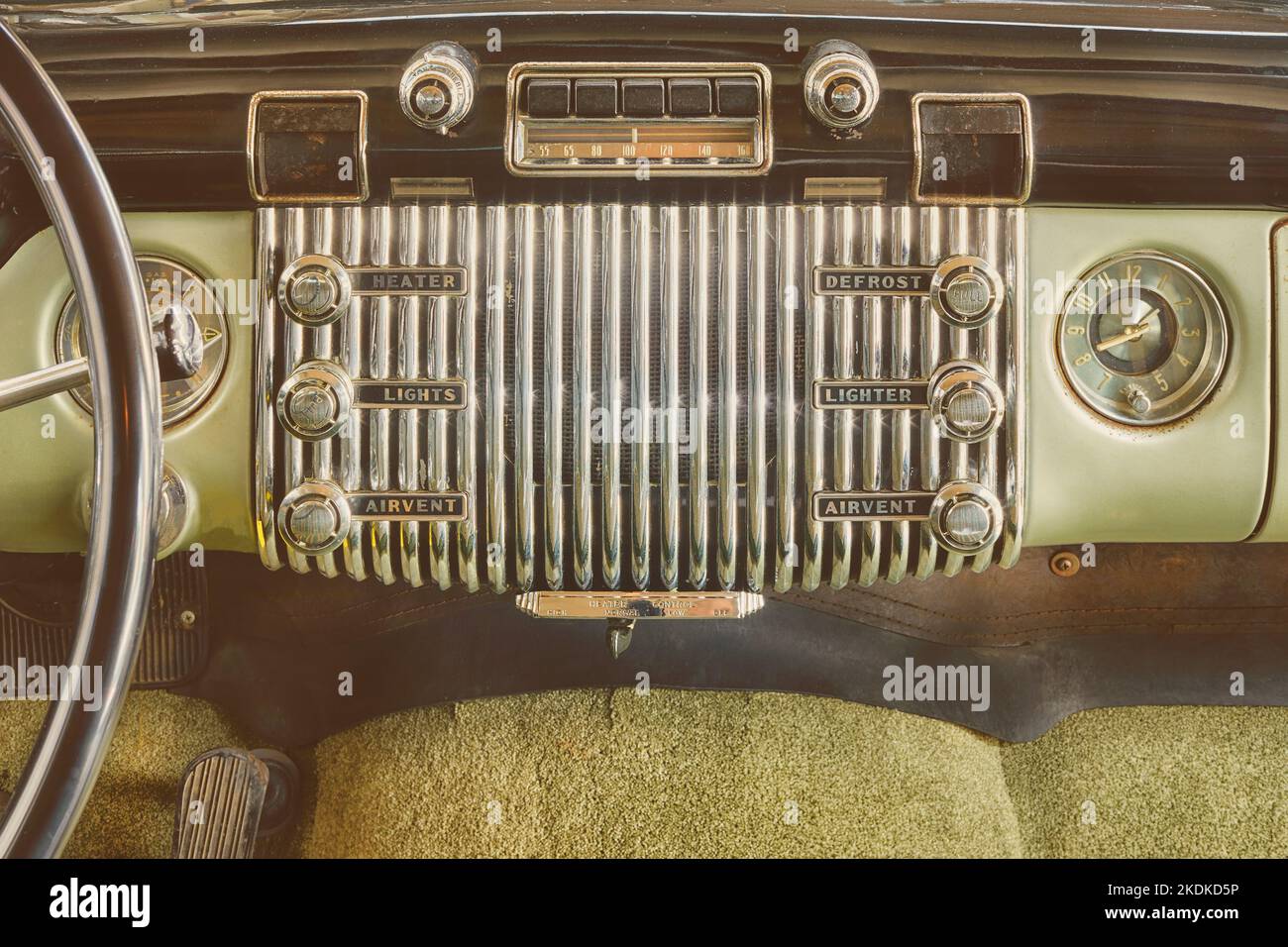 Old car radio inside a classic American car with chrome dashboard Stock Photo