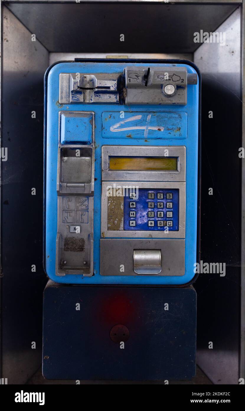 Close up of an old and broken payphone in Spain Stock Photo