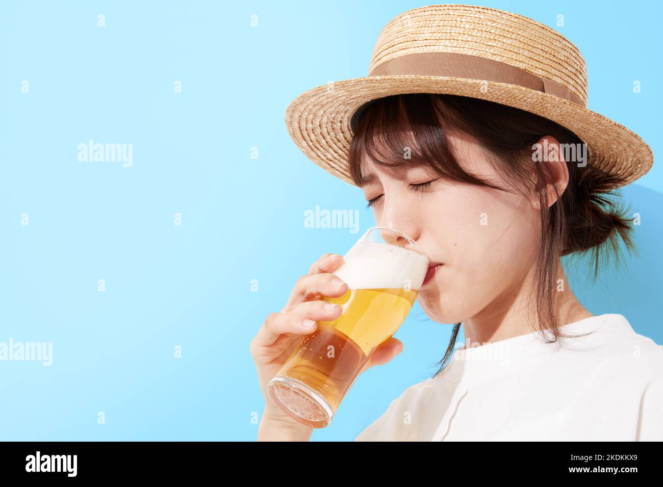 Young Japanese woman drinking beer Stock Photo