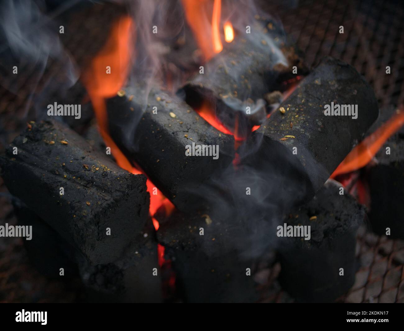 Burning and glowing charcoal briquette for barbecue grill Stock Photo