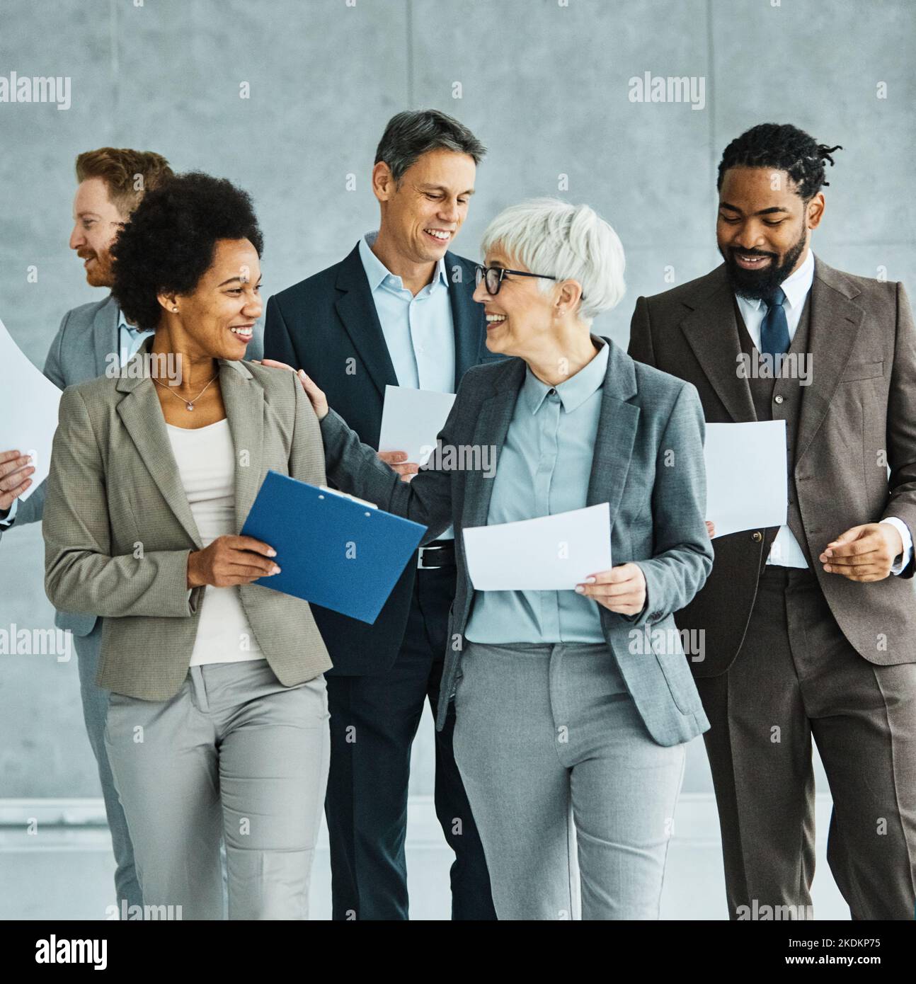 young business people meeting office teamwork group success corporate senior mature colleague together partner lobby Stock Photo