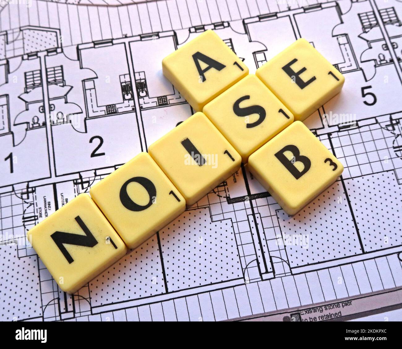 Noise ASB anti-Social Behaviour - Scrabble letters on plans for a housing scheme - Property Issues Stock Photo