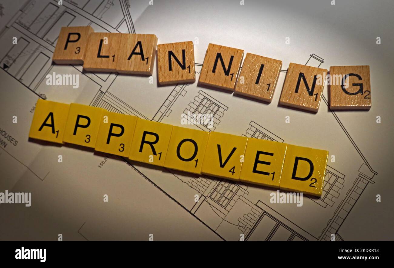 Planning Approved for new development - Scrabble letters on plans for a housing scheme - Property Issues Stock Photo