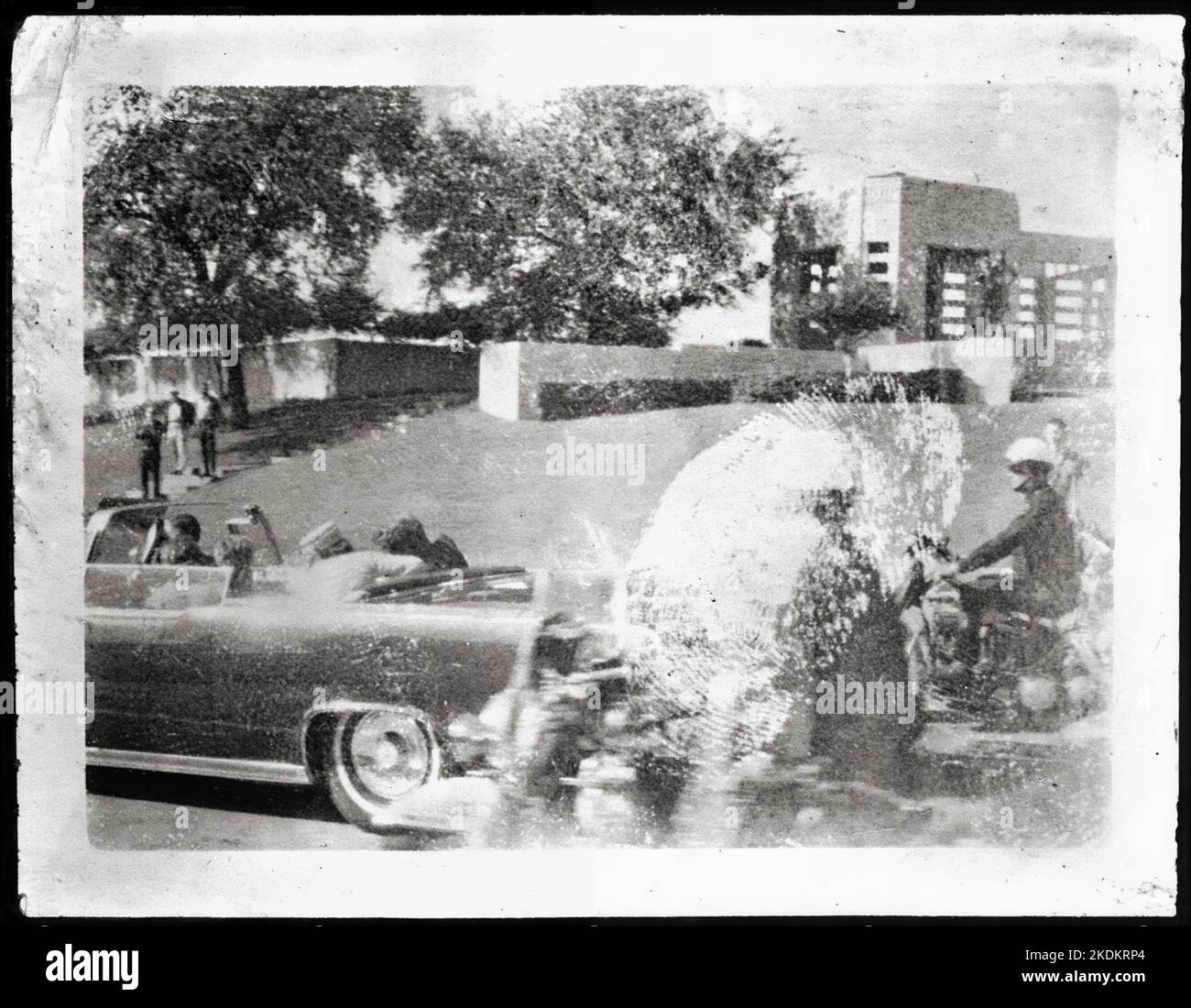 Mary Ann Moorman polaroid - A car accompanied by two motorcyclists, inside President Kennedy and his wife Jacqueline reacting to gunfire. Nov 22 1963 - Dallas Texas Stock Photo