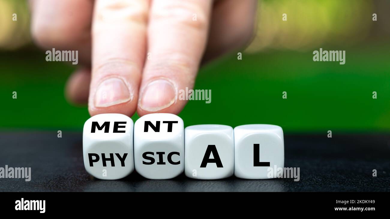 Symbol for the balance between physical and mental health. Dice form the words physical and mental. Stock Photo