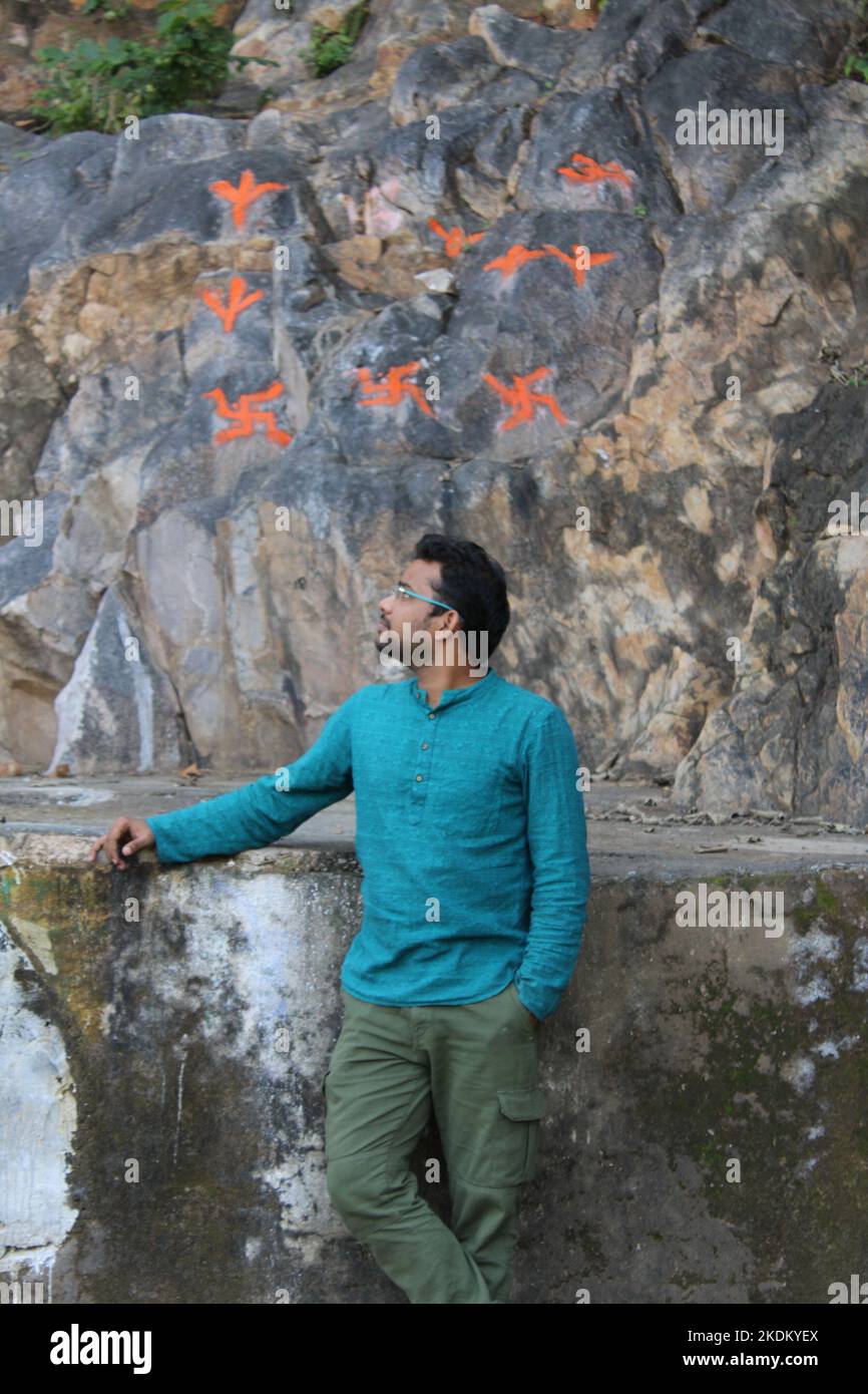 Man hiker hiking in mountain forest wearing cold weather accessories, wind jacket and backpack for camping outdoor. Guy portrait lifestyle. Stock Photo