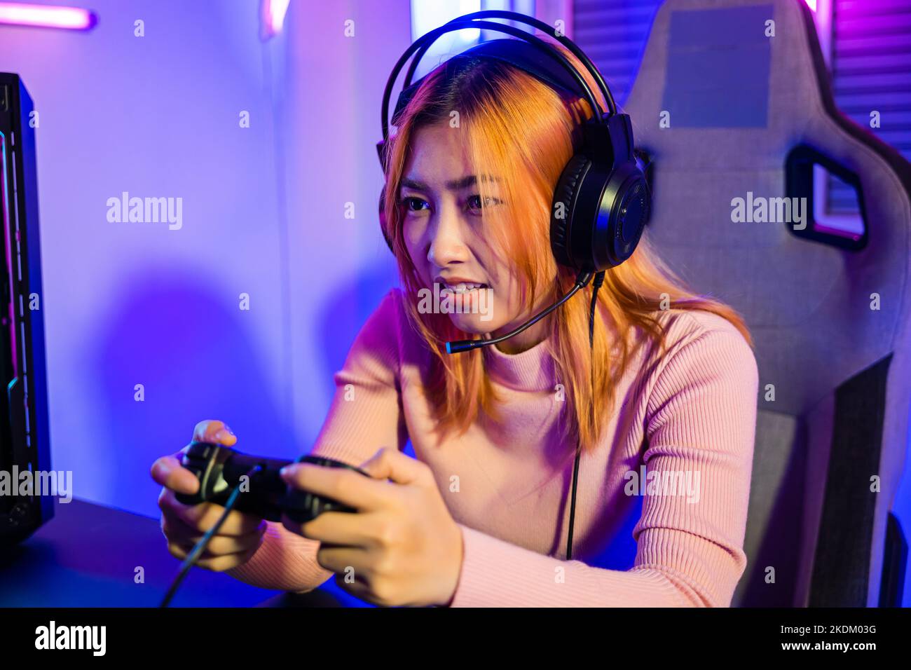 Woman wear gaming headphones playing live stream esports games console Stock Photo