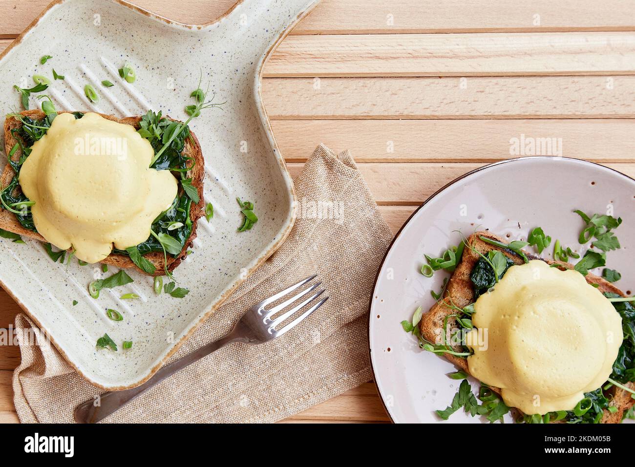 Vegan alternative eggs benedict with plantbased sauce, sourdough bread