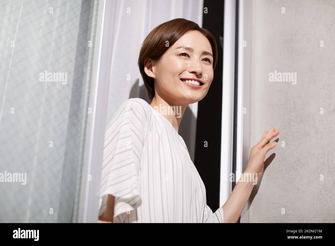 Japanese woman looking out the window Stock Photo - Alamy
