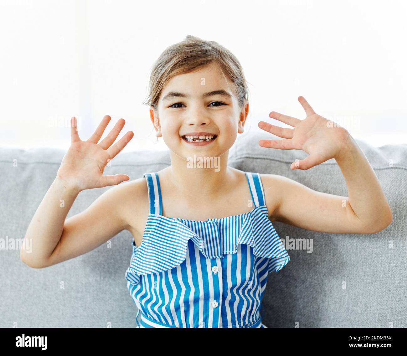 child portrait girl happy childhood cute smiling young waving kid fun happiness smile lifestyle cheerful hand Stock Photo