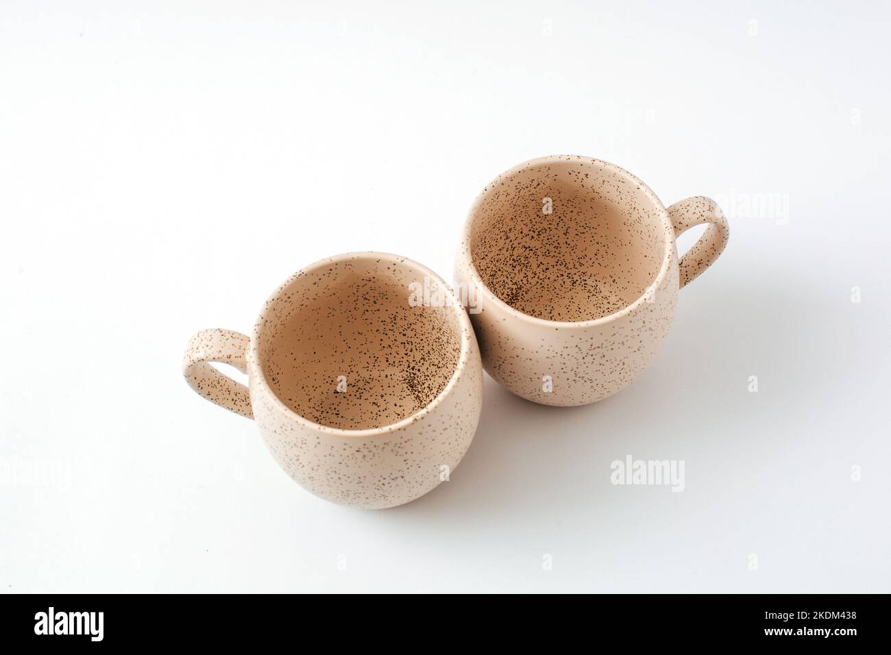 Beige coffee cups. View from above. Isolated on white background, cut out.  Stock Photo