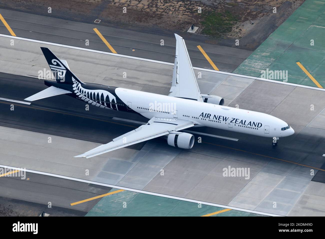 Air New Zealand Boeing 777 aircraft landing at airport. Airplane 77W registered as ZK-OKP. Plane of airline also know as Air NZ. Stock Photo