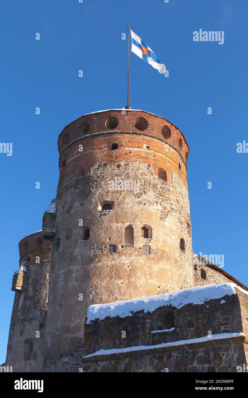 Olavinlinna fortress is under blue sky, vertical photo. This is a 15th-century three-tower castle located in Savonlinna, Finland. The fortress was fou Stock Photo