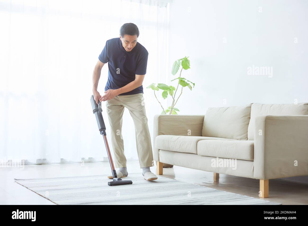 Japanese senior man cleaning at home Stock Photo Alamy