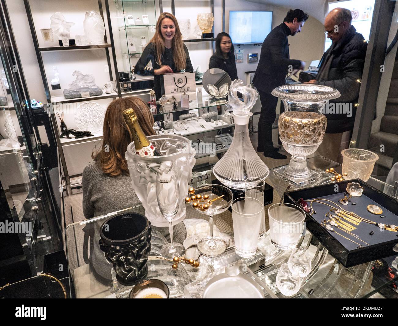 LALIQUE CHRISTMAS LUXURY gift shopping buying with shoppers in Lalique glassware store shop in traditional Burlington Arcade Piccadilly London Stock Photo