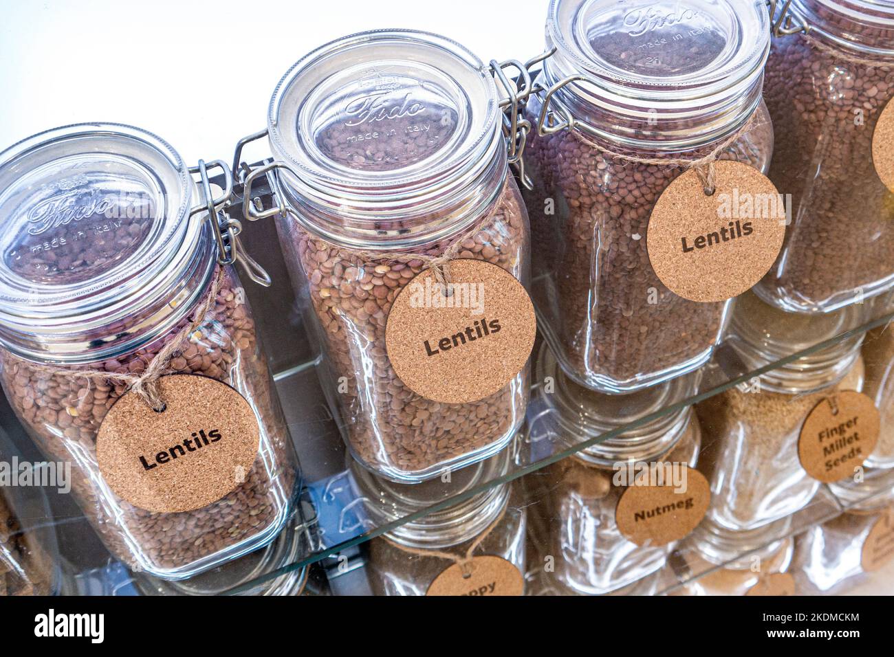 Lentils in display glass jars, source of B vitamins, iron, magnesium, potassium, and zinc. Also a source of plant-based protein and fiber. Superfood. Stock Photo