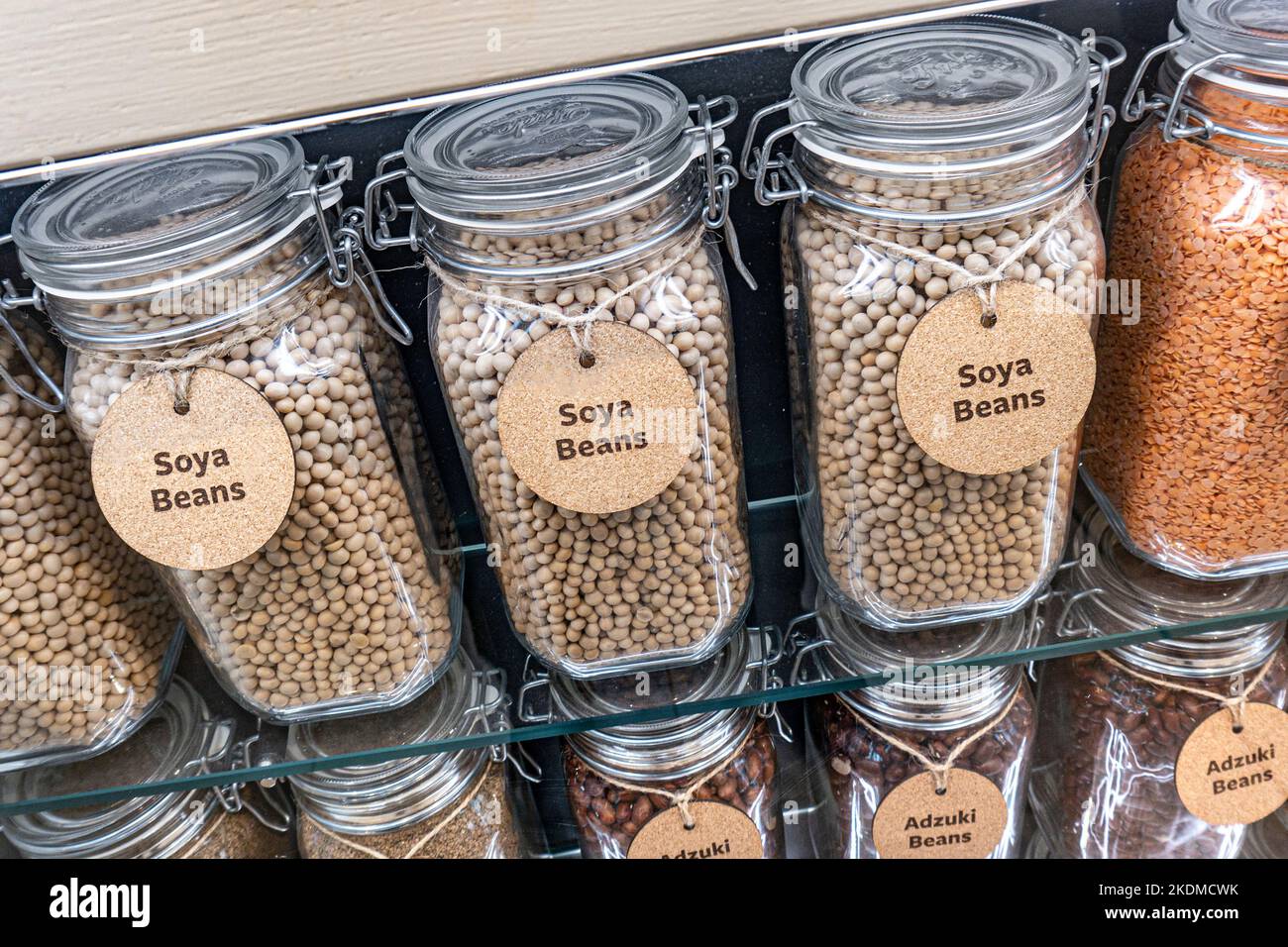 SOYA BEANS GLASS JARS DISPLAY The soybean, soy bean, or soya bean is a species of legume native to East Asia, widely grown for its healthy edible bean Stock Photo