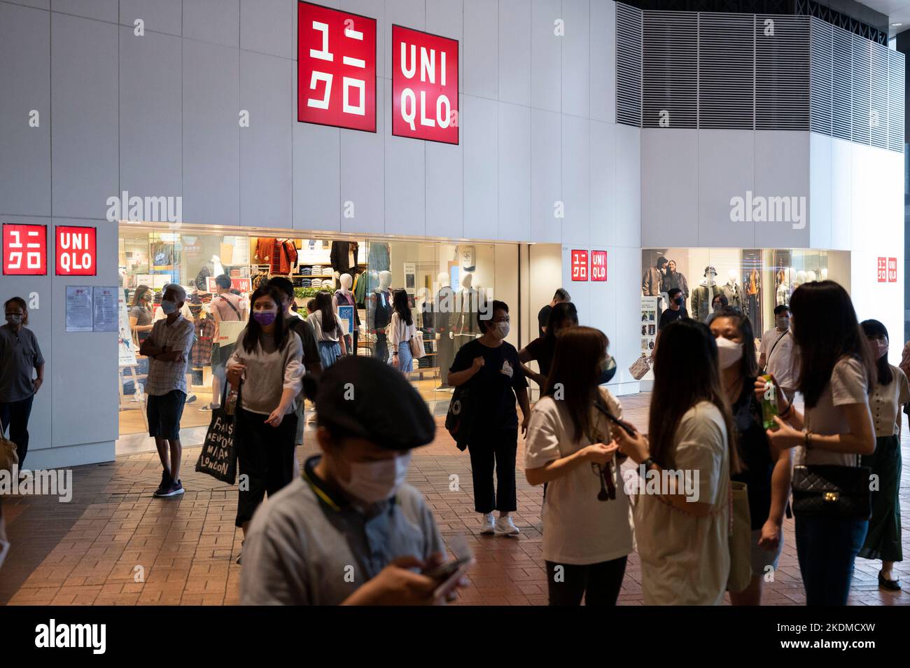 Shoppers walk past the Japanese clothing brand Uniqlo logo and store in  Hong Kong Stock Photo - Alamy