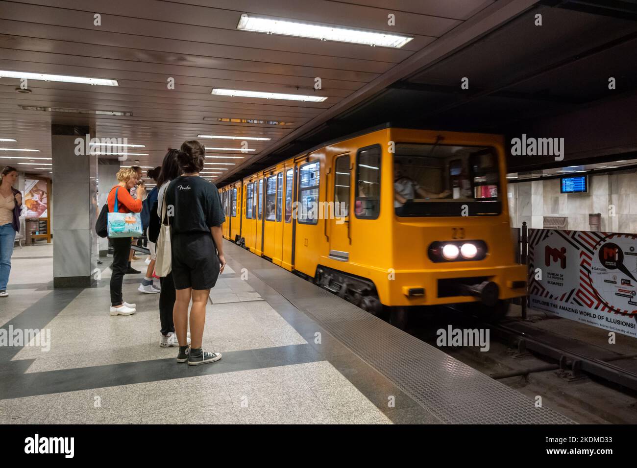 Budapest, Hungary - 3 September 2022: Passengers about to board yellow train wagons of Budapest subway Stock Photo