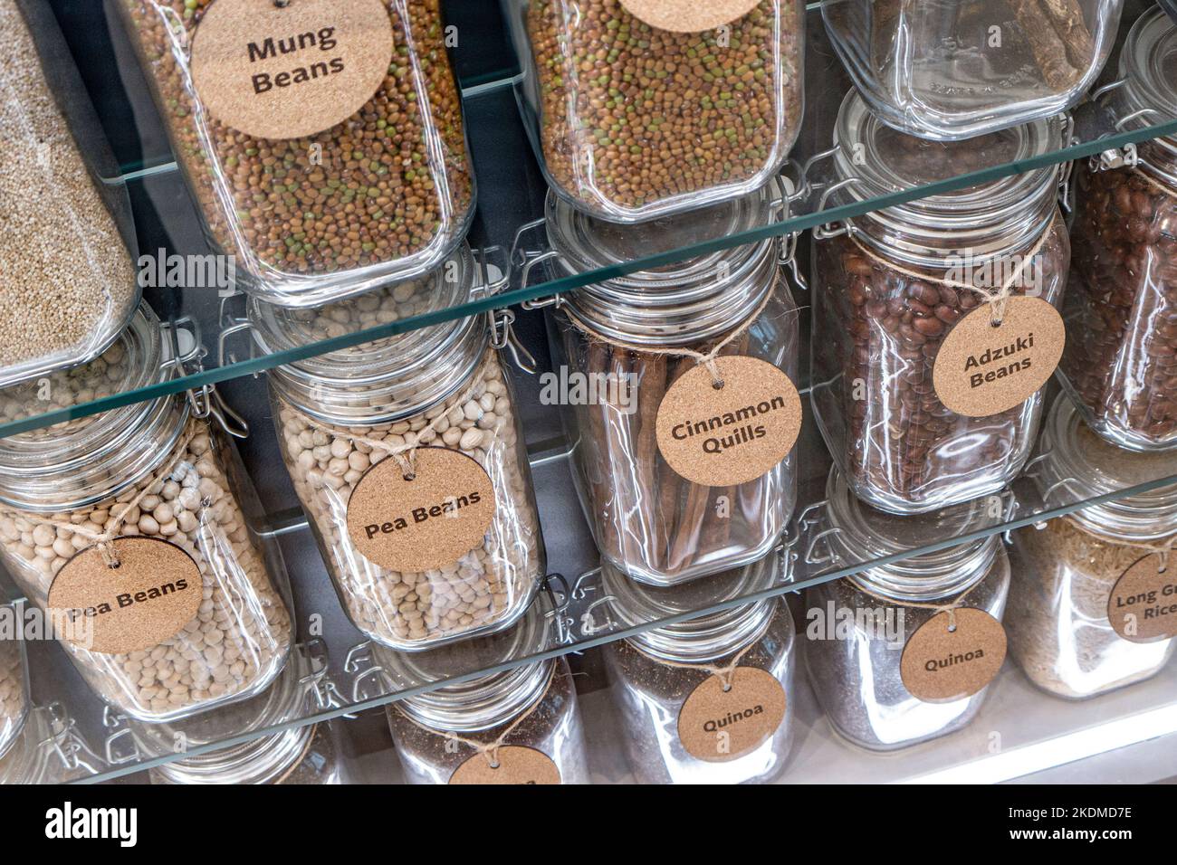 Health Foods Food Ingredients, Detox, Mung, Pea Beans, Cinnamon Quills, Adzuki beans in healthfood store situation in glass storage jars on display. Stock Photo