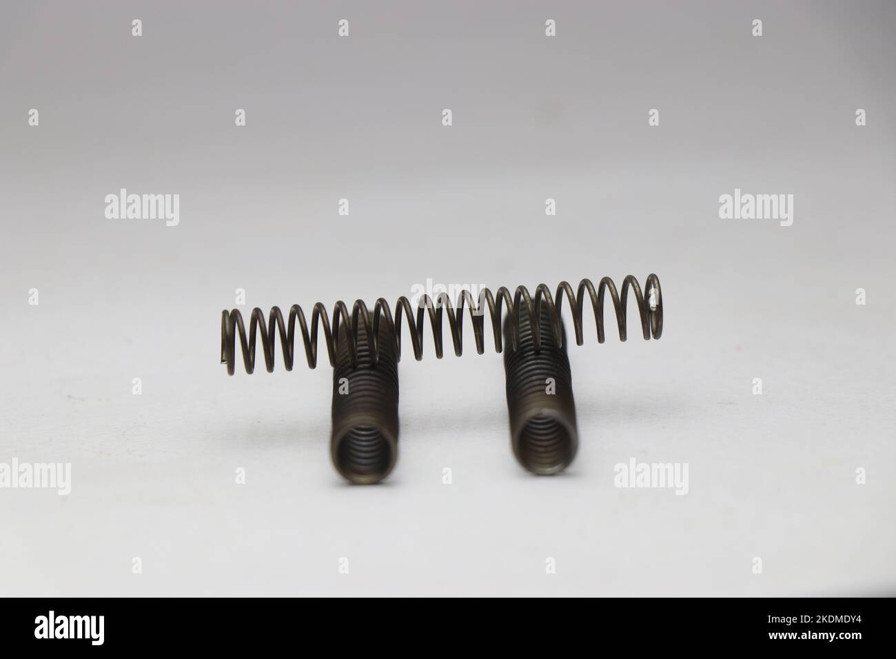 View of coiled metal compression springs placed in such a way to have a view from different angles Stock Photo