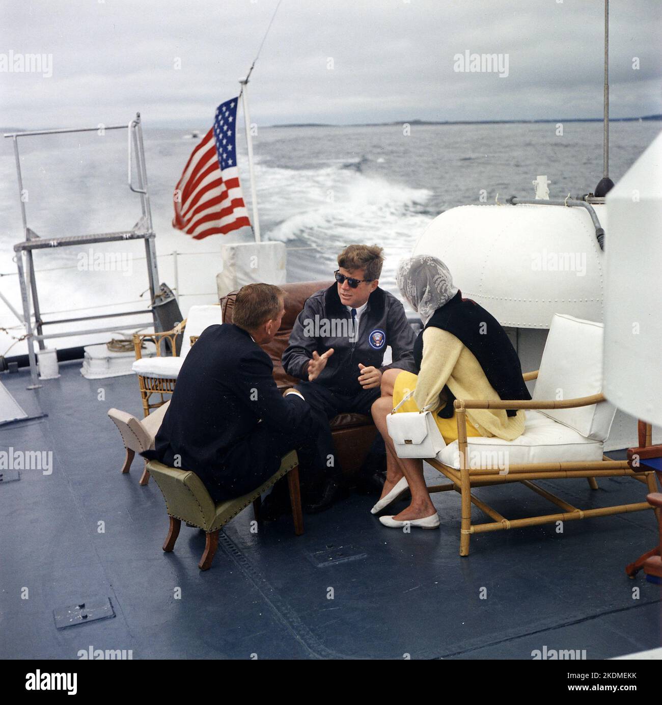 12 August 1962 - President JFK Vacations in Maine. Under Secretary of the Navy Paul Fay, President Kennedy, Patricia Kennedy Lawford. Boothbay Harbor, ME, aboard the US Coast Guard Cutter 'Guardian 1'.  Robert L. Knudsen photo. Stock Photo